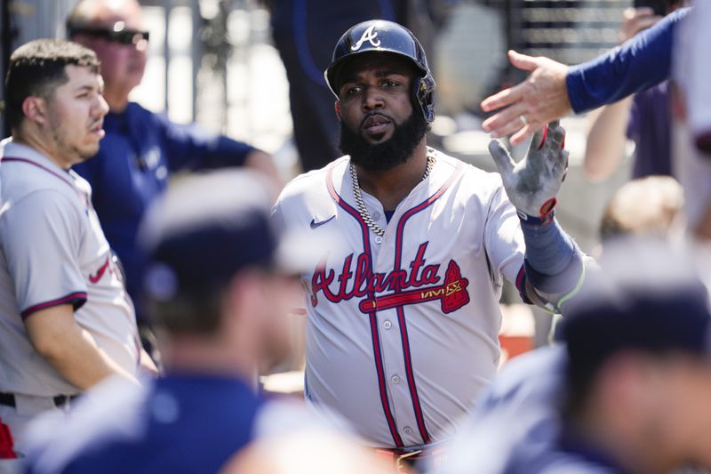 Atlanta Braves designated hitter Marcell Ozuna celebrates in the dugout after hitting a home run during the seventh inning of a baseball game against the Los Angeles Dodgers in Los Angeles, Sunday, May 5, 2024. (AP Photo/Ashley Landis)