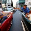 In this 1997 AJC file photo, Freaknik participants from New York pass off a video camera on Marietta Street.