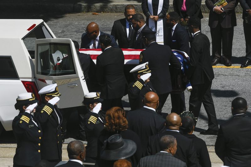 A CDC honor guard salutes as CDC researcher Timothy Cunningham is loaded into a hearse with family members looking on at lower right during a memorial service held Saturday at Morehouse April 21, 2018. Cunningham was found in the Chattahoochee River after being missing for seven weeks. (John Amis Contributed)