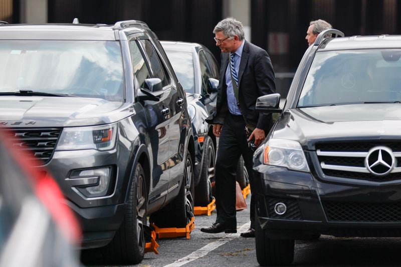 Bob Cheeley’s attorney, Chris Anulewicz, finds his car booted at the Federal Court in Atlanta on Monday, Aug. 28, 2023.    According to Anulewicz, multiple other attorneys got booted as well.  (Miguel Martinez / Miguel.Martinezjimenez@ajc.com)