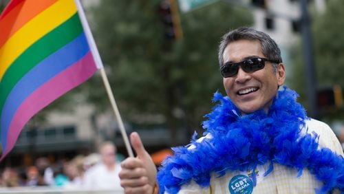 Former Atlanta City Councilman Alex Wan marches down Peachtree Street during the 2015 Atlanta Pride Parade. Wan has recently discovered that men are using his image to “catfish” Asian women around the world. BRANDEN CAMP/SPECIAL