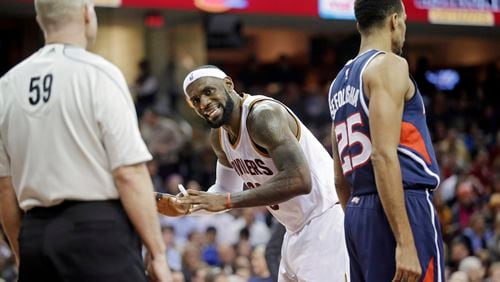 Cleveland Cavaliers' LeBron James, center, complains about a no-call to referee Gary Zielinski (59) in the third quarter of an NBA basketball game against the Atlanta Hawks Wednesday, Dec. 17, 2014, in Cleveland. James scored 21 points in the Cavaliers' 127-98 loss. (AP Photo/Mark Duncan) LeBron James' complaints to referee didn't stop Hawks from rolling to one-sided victory. (AP photo)