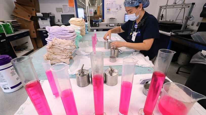 Officials at Medline's Lithia Springs plant say they think rotating shifts are an attraction to workers, since they have weekdays off so often. Here, Daisy Foreman runs tests in the Medline quality assurance lab. “Curtis Compton / Curtis.Compton@ajc.com”