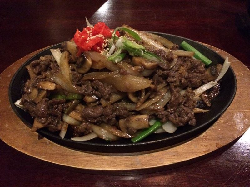 The owners of Natsu Sushi Bar & Ocean Grill in Alpharetta are Korean, and they offer cuisine from their homeland like this platter of bulgogi (grilled beef) with mushrooms and onions. CONTRIBUTED BY WENDELL BROCK