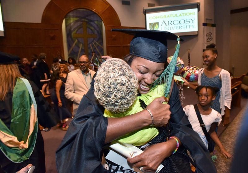 June 8, 2019 Atlanta - Cheryl Walker hugs her friend Camille Jackson after she received her degree during 2019 Argosy University Atlanta Commencement at Church of Christ at Bouldercrest in Atlanta on Saturday, June 8, 2019.  HYOSUB SHIN / HSHIN@AJC.COM