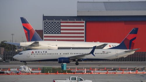 A Delta Airlines Boeing 737, front, passes another Delta Airlines Boeing 777 on the tarmac at Salt Lake City International Airport, Sept. 16, 2020. (Robyn Beck/AFP/Getty Images/TNS)