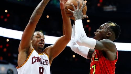 Atlanta Hawks guard Dennis Schroder (17) goes up for a shot as Cleveland Cavaliers forward Channing Frye (8) defends in the first half of an NBA basketball game, Sunday, April 9, 2017, in Atlanta.