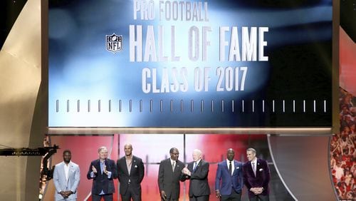 Former NFL players LaDainian Tomlinson, from the left, Morten Andersen, Jason Taylor, Kenny Easley, Jerry Jones, Terrell Davis and Kurt Warner are announced as inductees into the Pro Football Hall of Fame at the 6th annual NFL Honors at the Wortham Center on Saturday, Feb. 4, 2017, in Houston. (Photo by John Salangsang/Invision for NFL via AP)