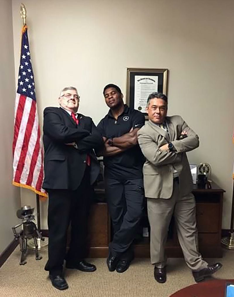 A 2017 photo shows Herschel Walker, center, with former Cobb Sheriff Neil Warren, left, and Cobb Sheriff Milton Beck. Walker possesses and honorary badge from the Sheriff's Office. (Facebook)