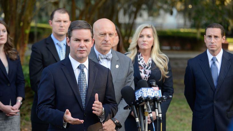 Lead prosecutor Chuck Boring (foreground) and (to Boring's left) Cobb County District Attorney Vic Reynolds, prosecutor Susan Treadaway and prosecutor Jesse Evans speak with the media outside the courthouse in Brunswick. (John Carrington / for the AJC)