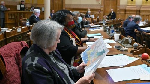 State Sen. Nan Orrock, D-Atlanta, examines newly drawn congressional maps during the General Assembly's 2021 special session for redistricting. Lawmakers will return to the Georgia Capitol on Wednesday to redraw those maps in a way that will comply with a federal judge's order. (Hyosub Shin / Hyosub.Shin@ajc.com)