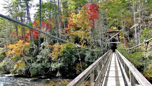 The Benton MacKaye Trail takes hikers over the rugged Toccoa River in Fannin County via the famed "swinging bridge" (shown here). The Benton MacKaye Trail Association now wants Congress to designate the trail as the nation's 12th "National Scenic Trail." (Charles Seabrook for The Atlanta Journal-Constitution)