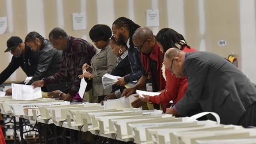 Workers recount the votes cast in the Atlanta mayoral election runoff  at the Fulton County Elections Preparation Center on Thursday, Dec. 14, 2017. Keisha Lance Bottoms won the race by more than 800 votes against Mary Norwood.