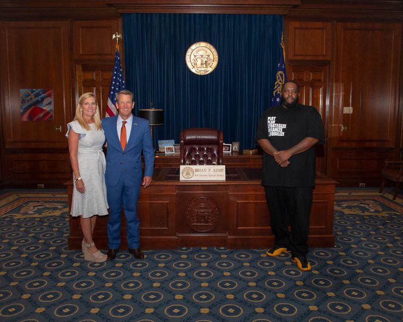 Gov. Brian Kemp and First Lady Marty Kemp pose for a picture with Atlanta hip-hop star Killer Mike in his ceremonial office. Credit: Kemp's office.