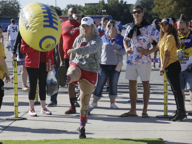 10/30/21 - Jacksonville - Fans kick a giant inflatable football at one of the fan events before the annual NCCA  Georgia vs Florida game at TIAA Bank Field in Jacksonville.   Bob Andres / bandres@ajc.com