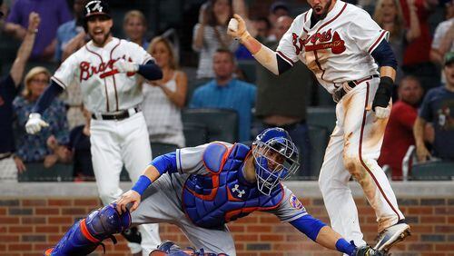 Dansby Swanson slides in with the winning run in the bottom of the ninth Friday as the Braves defeated the Mets 3-2 at SunTrust Park.