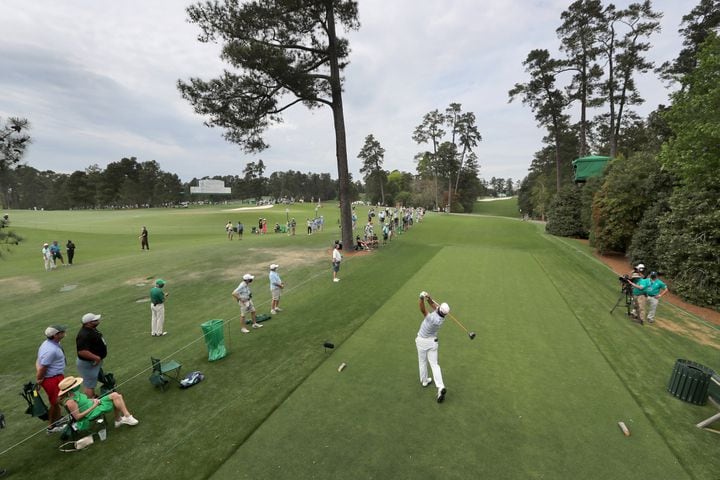 April 8, 2021, Augusta: Only a few patrons watch as Hideki Matsuyama tees on the eighteenth hole during the first round of the Masters at Augusta National Golf Club on Thursday, April 8, 2021, in Augusta. Curtis Compton/ccompton@ajc.com