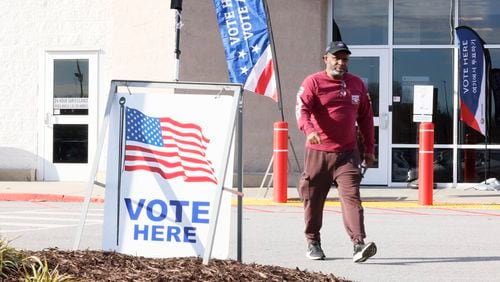 A voter leaves the Gwinnett County election office Monday, the first day of early voting for the Georgia presidential primary. (Miguel Martinez / miguel.martinezjimenez@ajc.com)
