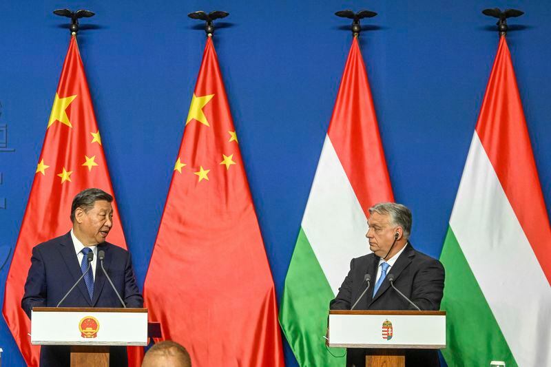 Chinese President Xi Jinping, left, speaks during his joint press conference with Hungarian Prime Minister Viktor Orban following their talks at the PM's office, the former Carmelite Monastery, in Budapest, Hungary, Thursday, May 9 2024. (Szilard Koszticsak/MTI via AP)