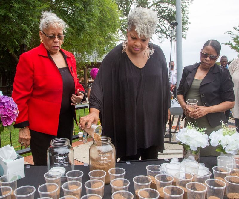 Charles Hale's family member Inger Williams pours dirt into a jar during the soil collection ceremony in Lawrenceville on Juneteenth, Saturday 19, 2021, in memory of Hale's 1911 lynching. Soil from the lynching site will be housed at the Legacy Museum, near the National Memorial for Peace and Justice in Montgomery, Alabama. (Photo: Steve Schaefer for The Atlanta Journal-Constitution)