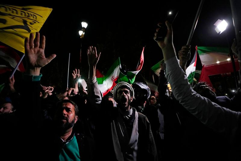 Iranian demonstrators chant slogans during an anti-Israeli gathering in front of the British Embassy in Tehran, Iran, early Sunday, April 14, 2024. Iran launched its first direct military attack against Israel on Saturday. (AP Photo/Vahid Salemi)