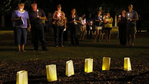 Metro area residents participate in a Sept. 12 candlelight vigil sponsored by the Metro Atlanta Chapter of the American Foundation for Suicide Prevention in Piedmont Park in Atlanta. The event helps promote awareness that depression and other mental illnesses are just that - illnesses. Not weaknesses or character flaws. Depression is one of the leading causes of suicide.