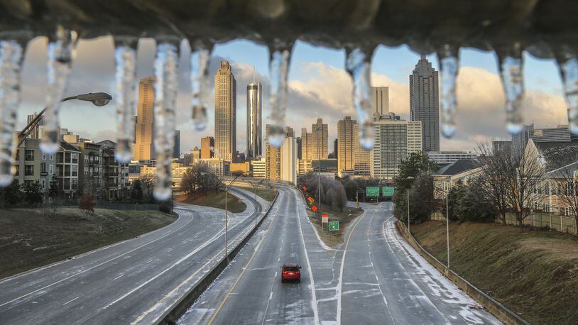 Friday’s ice storm, which left this icy coating over a railing at Freedom Parkway, knocked out power for more than 50,000 Georgia Power customers, mostly in metro Atlanta. JOHN SPINK /JSPINK@AJC.COM