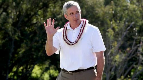 In this Jan. 8, 2017, file photo, PGA Commissioner Jay Monahan waves to fans before speaking after the final round of the Tournament of Champions golf event, at Kapalua Plantation Course in Kapalua, Hawaii.  In his first year as PGA Tour commissioner, Jay Monahan said his top priority was to make Arnold Palmer proud. He has seen enough evidence halfway through the year to believe the tour is on the right track. (AP Photo/Matt York, File)
