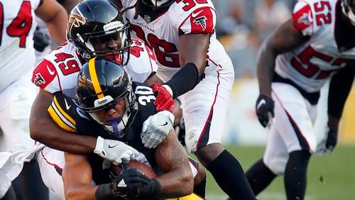 Falcons' Deron Washington (49) helps bring down Pittsburgh running back James Conner during a preseason game Aug. 20, 2017, at Heinz Field in Pittsburgh. (Justin K. Aller/Getty Images)