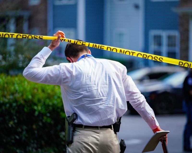 A Cobb County police detective enters the crime scene following Thursday's fatal shooting at a Kennesaw-area apartment complex.
Ben Hendren for the AJC