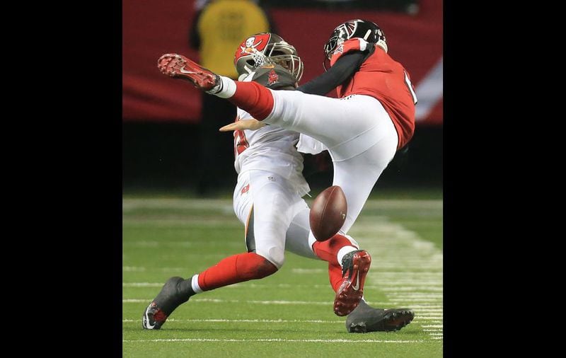 Falcons quarterback Matt Ryan fumbles as he is sacked by Buccaneers defensive end Howard Jones on the last drive of the game in over time in a football game on Sunday, Nov. 1, 2015, in Atlanta. The Falcons lost 23-20 to the Buccaneers in over time. (Photo by Curtis Compton)