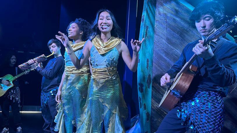 Monica Ortiz (center) sings "Under the Sea" with the rest of the musical crew of mer-persons at "The Little Mermaid" experience at CAMP in Dunwoody, during a test run on May 30, 2023, four days before official opening. RODNEY HO/rho@ajc.com