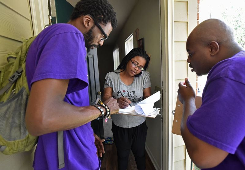 Volunteers with the New Georgia Project help a new voter to register in 2017. Stacey Abrams' voter registration network changed the way Democrats thought about running elections in the Deep South. (Hyosub Shin / AJC photo 2017)