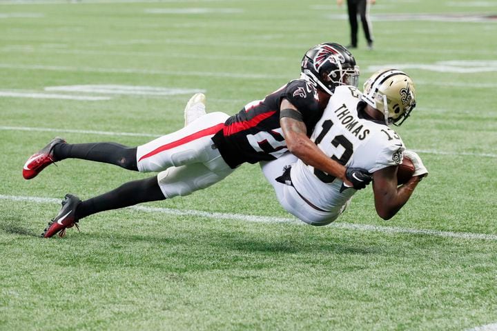 Saints wide receiver Michael Thomas catches a touchdown pass while being covered by Falcons cornerback A.J. Terrell in the fourth quarter Sunday. (Miguel Martinez / miguel.martinezjimenez@ajc.com)