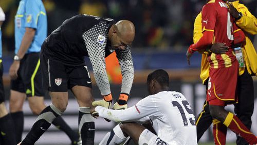 United States goalkeeper Tim Howard, left, helps United States' Maurice Edu, bottom, get up at the end of the World Cup round of 16 soccer match between the United States and Ghana at Royal Bafokeng Stadium in Rustenburg, South Africa, Saturday, June 26, 2010. Ghana won 2-1, advancing to the World Cup quarterfinals.