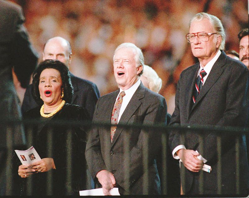 from left Coretta Scott King former President Jimmy Carter and Billy Graham stand and sing Blessed Assurance All Hail the Power at the Atlanta Billy Graham Crusade at the Georgia Dome in 1994. About 49,800 people showed for the crusade on its first night in Atlanta Frank Niemeir Staff