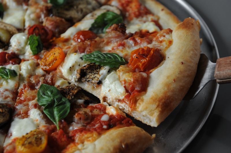 The Comet Pub & Lanes offers hand-tossed pizzas, including the Farmer with Comet tomato sauce, ricotta, Pine Street Market summer sausage and seasonal veggies. / AJC file photo