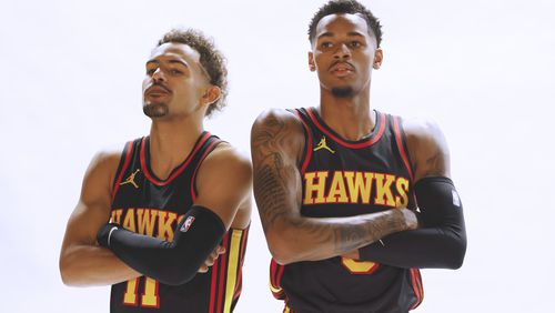 Trae Young and Dejounte Murray pose during Hawks Media Day Oct. 2. The guards will be key for the team as it prepares to open the 2023-24 season Wednesday in Charlotte. (Miguel Martinez /miguel.martinezjimenez@ajc.com)