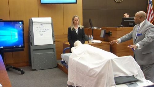 Dr. Susanne Hardy of Emory Hospital and lead prosecutor Clint Rucker use a stretcher with a manequin to demonstrate to the jury how Hardy was postitioned next to Diane McIver. The demonstration was part of Hardy's testimony during the Tex McIver murder trial on March 16, 2018 at the Fulton County Courthouse. (Channel 2 Action News)