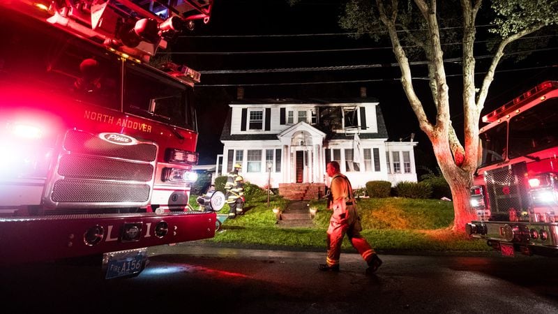 Firefighters inspect a home after a gas explosions on September 13, 2018 in North Andover, Massachusetts. Gas explosions in three communities north of Boston have left multiple homes on fire.