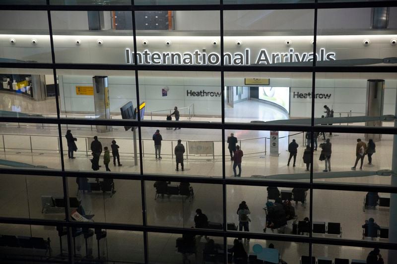 FILE - People in the arrivals area at Heathrow Airport in London, Jan. 26, 2021. (AP Photo/Matt Dunham, File)
