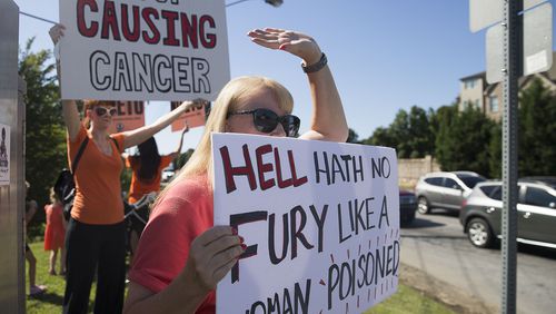 Jenni Shover holds a sign during a protest against the Sterigenics plant held Aug. 29 at the nearby intersection of Atlanta and Plant Atkinson roads. “I didn’t sign up to be anybody’s lab rat,” she told the AJC recently, “but that’s what I am.” ALYSSA POINTER / ALYSSA.POINTER@AJC.COM