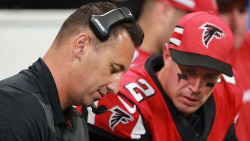Falcons offensive coordinator Steve Sarkisian and quarterback Matt Ryan confer on the sidelines during the fourth quarter against the New Orleans Saints in an NFL football game on Sunday, Sept 23, 2018, in Atlanta.   Curtis Compton/ccompton@ajc.com