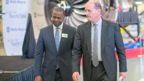 Former Delta Air Lines CEO Richard Anderson, shown here in 2015 at the airline’s Atlanta maintenance center with Atlanta Mayor Kasim Reed, walked away with almost $72 million in Delta stock when he retired last year. BRANDEN CAMP/SPECIAL