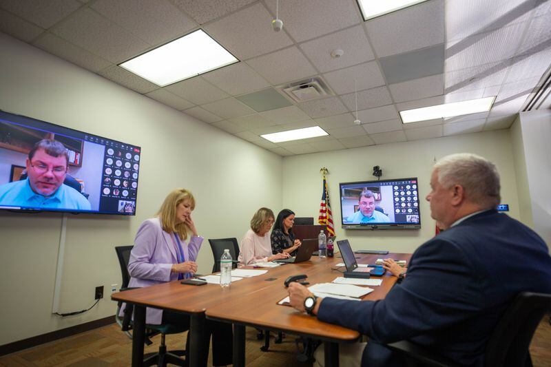 Commissioners gather virtually while members of the public speak in person at the Georgia Professional Standards Commission meeting to discuss wording changes in teacher preparation rules on Thursday, July 13, 2023. (Katelyn Myrick/katelyn.myrick@ajc.com)