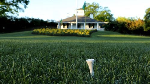 A golf fan leaves a tee stuck in the grass as a quiet testament to the game of golf in front of the clubhouse at Augusta National Golf Club on Tuesday, April 5, 2016, in Augusta.