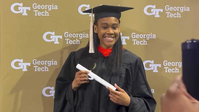 Deanna Yancey holds a diploma after receiving her master’s degree in electrical and computer engineering from Georgia Tech on May 3, 2024. Her grandfather, Ronald Yancey, handed her the degree during the ceremony. He's the first Black person to graduate from Georgia Tech. (Courtesy of Georgia Tech)