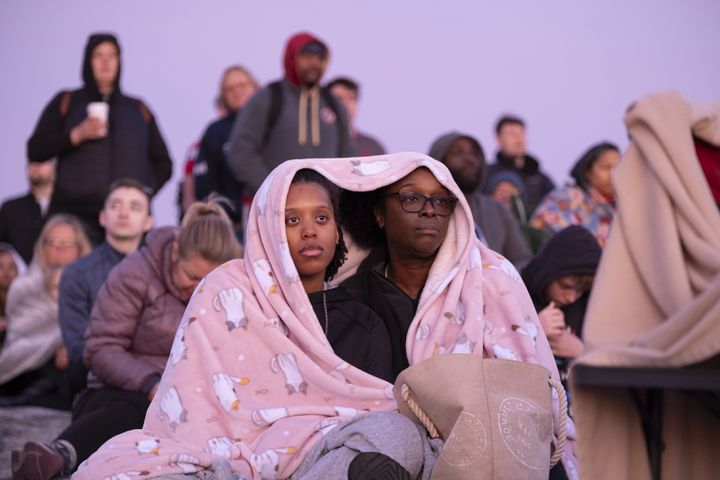 Kiara Johnson, left, and her mom Vanessa Canty huddle together under a blanket to keep warm during Easter sunrise service on top of Stone Mountain on Sunday, March 31, 2024.   (Ben Gray / Ben@BenGray.com)
