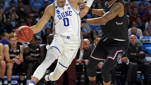 Duke’s Jayson Tatum, left, drives past South Carolina’s Chris Silva during the first half in a second-round game of the NCAA men’s college basketball tournament, in Greenville, S.C., on March 19, 2017. (AP Photo/Rainier Ehrhardt, File)