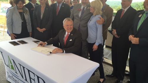 Gov. Nathan Deal signs the state budget in May 2016 at the new campus of Lanier Technical College, located near his hometown of Gainesville. The state borrowed more than $130 million to build new facilities for the campus, which Deal moved from one end of Hall County to the other.